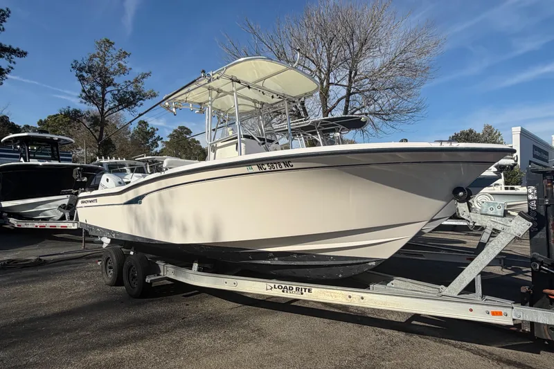 The Image of 2001 Grady-White Advance 247 boat on trailer, parked outdoors under clear sky. - 1