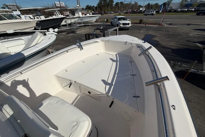 Slide: The Image of 2001 Grady-White Advance 247 boat with open storage compartments on calm water. - 10