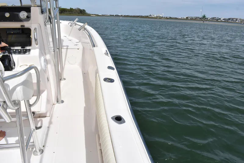 Slide: The Image of 2001 Grady-White Advance 247 boat on calm water, showcasing deck and controls. - 15