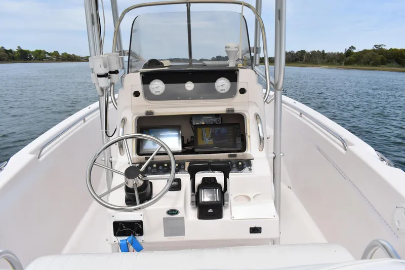 Slide: The Image of 2001 Grady-White Advance 247 boat console with steering wheel and navigation equipment. - 23