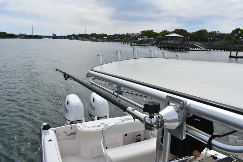Slide: The Image of 2001 Grady-White Advance 247 boat with dual Suzuki engines on a calm waterway. - 26