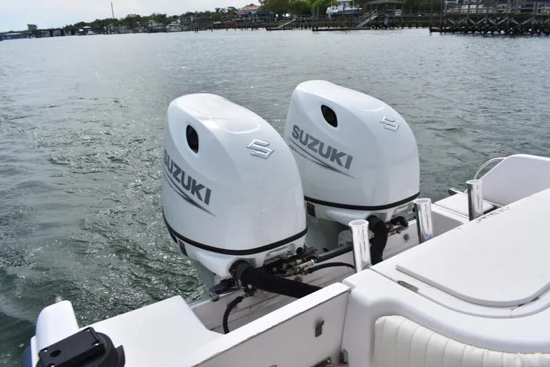 Slide: The Image of Twin Suzuki outboard motors on a 2001 Grady-White Advance 247 boat, dockside view. - 28