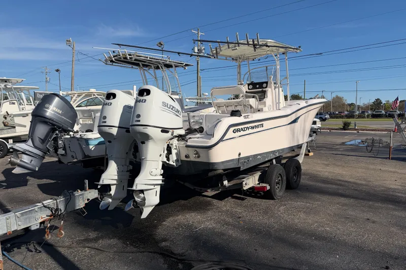 Slide: The Image of 2001 Grady-White Advance 247 boat with dual Suzuki outboard motors on a trailer. - 3