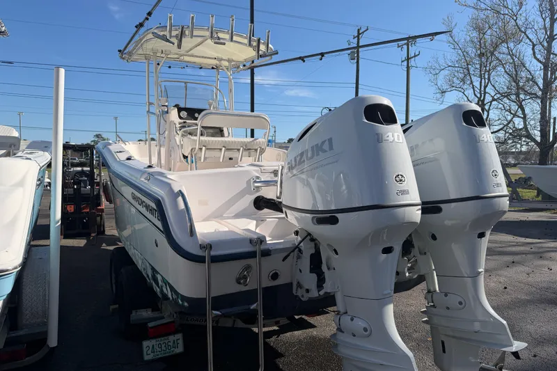 Slide: The Image of 2001 Grady-White Advance 247 boat with twin Suzuki 140 engines, parked outdoors. - 4