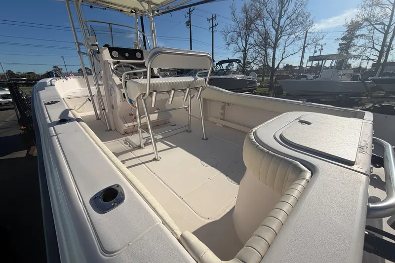 Slide: The Image of 2001 Grady-White Advance 247 boat interior with seating and console, parked outdoors. - 6