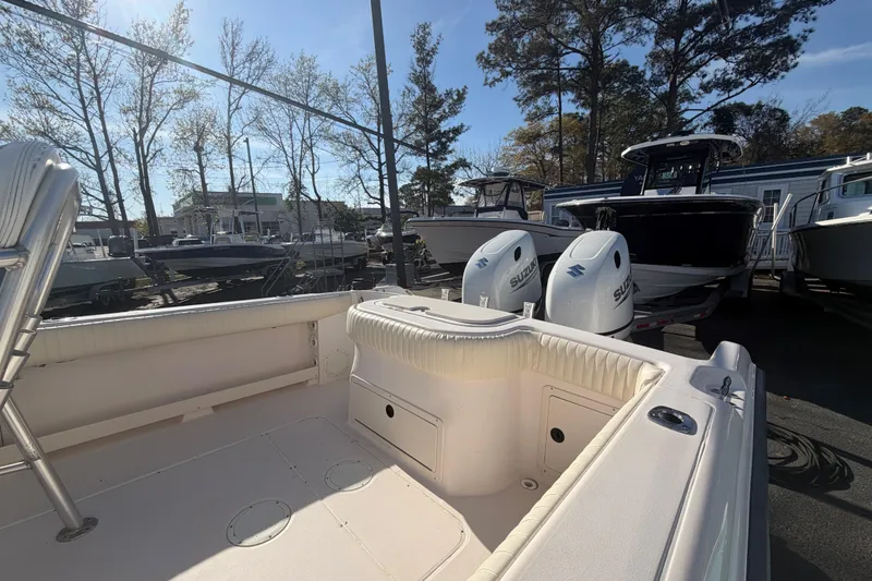 Slide: The Image of 2001 Grady-White Advance 247 boat with Suzuki engines, docked outdoors. - 7