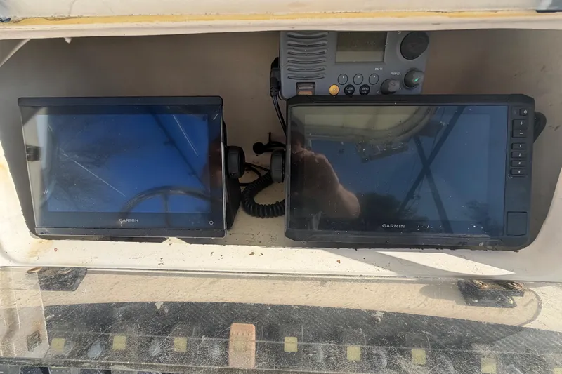 Slide: The Image of Garmin navigation screens and radio on a 2001 Grady-White Advance 247 boat. - 8