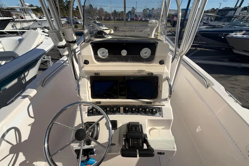 Slide: The Image of 2001 Grady-White Advance 247 boat dashboard with steering wheel and navigation instruments. - 9