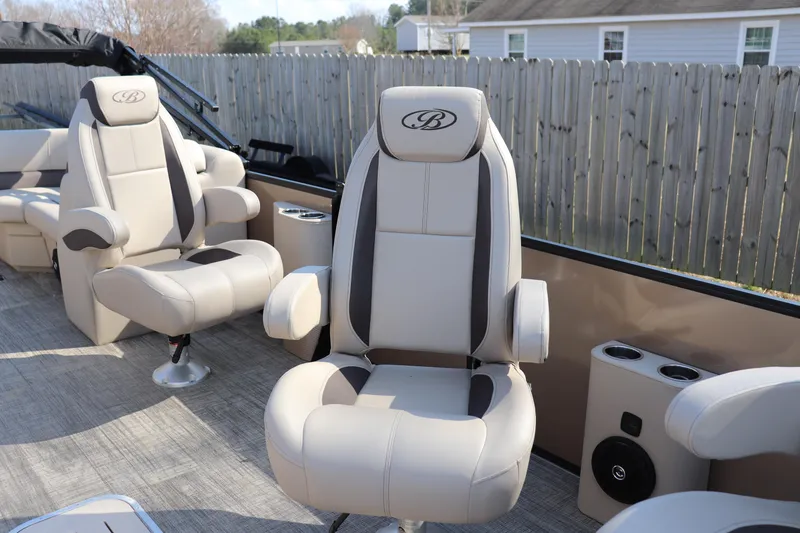 Slide: The Image of 2026 Bentley Pontoons Legacy 223 DL Navigator interior with luxurious seating and cup holders. - 4