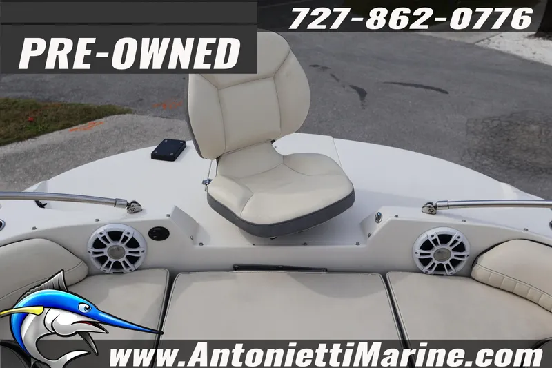 Slide: The Image of Pre-owned 2023 Stingray 212 SC boat interior with seating and speakers, Antonietti Marine. - 13