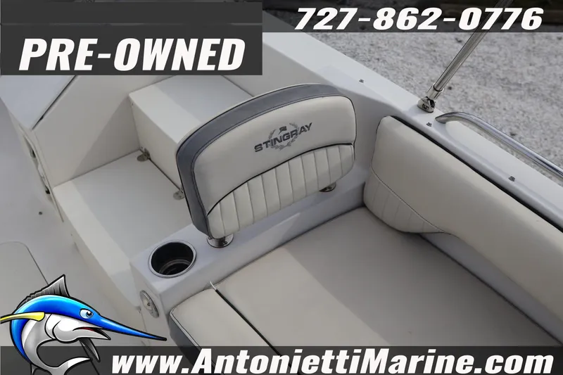 Slide: The Image of Pre-owned 2023 Stingray 212 SC boat interior with logo and contact details. - 15