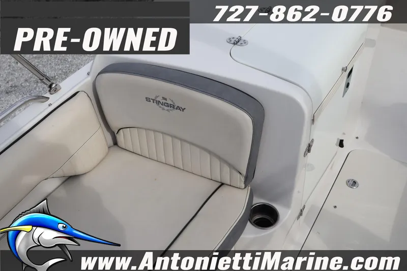 Slide: The Image of Pre-owned 2023 Stingray 212 SC boat interior with seating, Antonietti Marine contact details. - 16