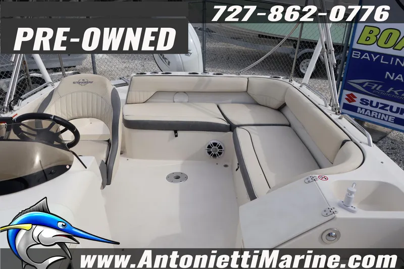 Slide: The Image of Pre-owned 2023 Stingray 212 SC boat interior at Antonietti Marine dealership. - 17