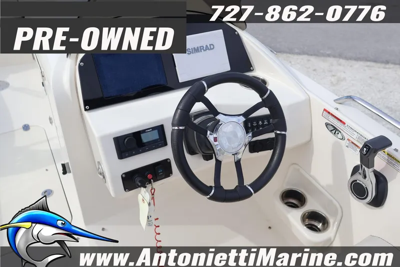 Slide: The Image of Pre-owned 2023 Stingray 212 SC boat dashboard with steering wheel and controls. - 20