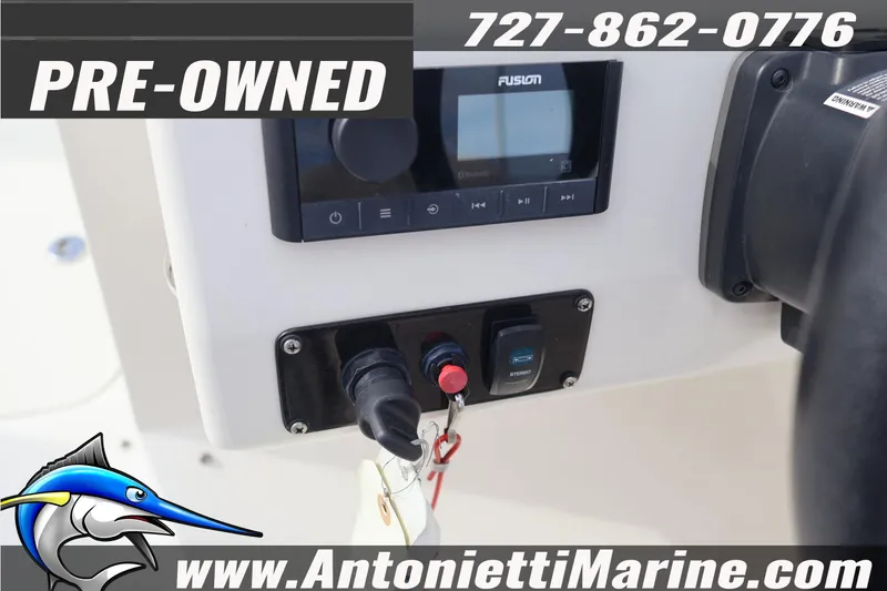 Slide: The Image of Pre-owned 2023 Stingray 212 SC boat dashboard with stereo system and controls. - 22