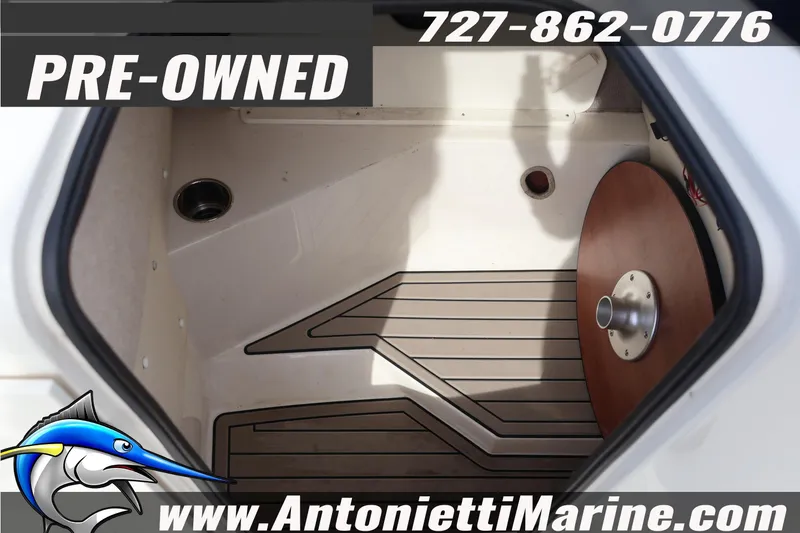 Slide: The Image of Pre-owned 2023 Stingray 212 SC boat interior with flooring and table base. - 26