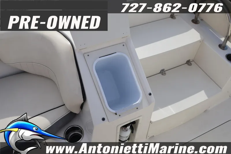 Slide: The Image of Pre-owned 2023 Stingray 212 SC boat interior with seating and storage. - 28
