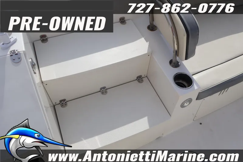 Slide: The Image of Pre-owned 2023 Stingray 212 SC boat interior with seating and cup holder. - 29