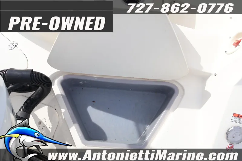 Slide: The Image of Pre-owned 2023 Stingray 212 SC boat interior with storage compartment, Antonietti Marine contact details. - 31