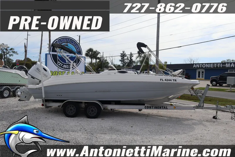 Slide: The Image of Pre-owned 2023 Stingray 212 SC boat on trailer at Antonietti Marine dealership. - 4