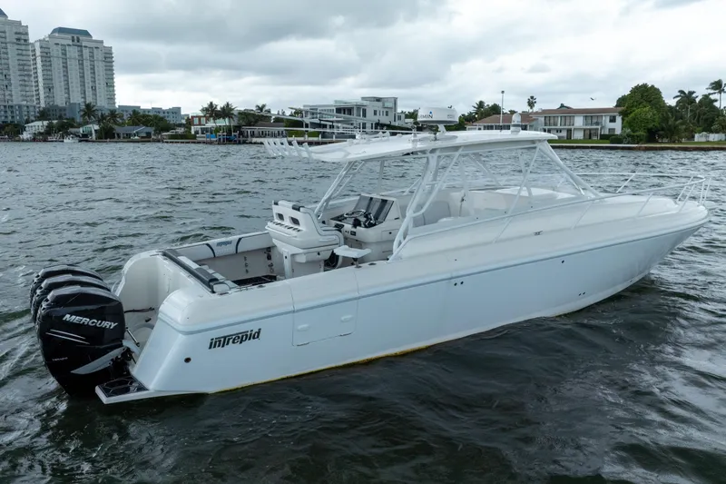 The Image of 2008 Intrepid 390 Sport Yacht on water, featuring triple Mercury engines. - 1