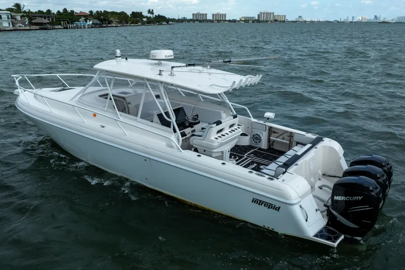 Slide: The Image of 2008 Intrepid 390 Sport Yacht cruising on open water with Mercury engines. - 11