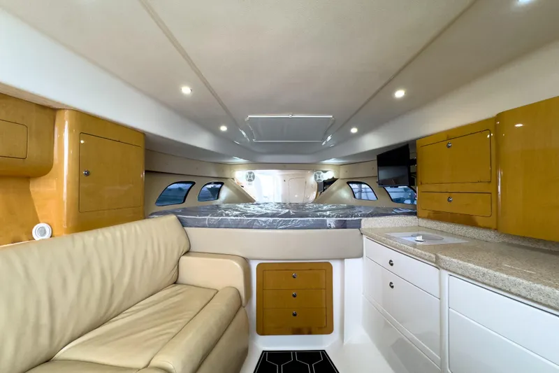 Slide: The Image of Interior of 2008 Intrepid 390 Sport Yacht with beige seating and wooden cabinetry. - 16