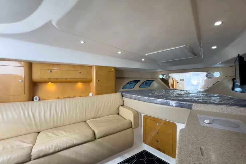 Slide: The Image of Interior of 2008 Intrepid 390 Sport Yacht with beige seating and wooden cabinetry. - 17