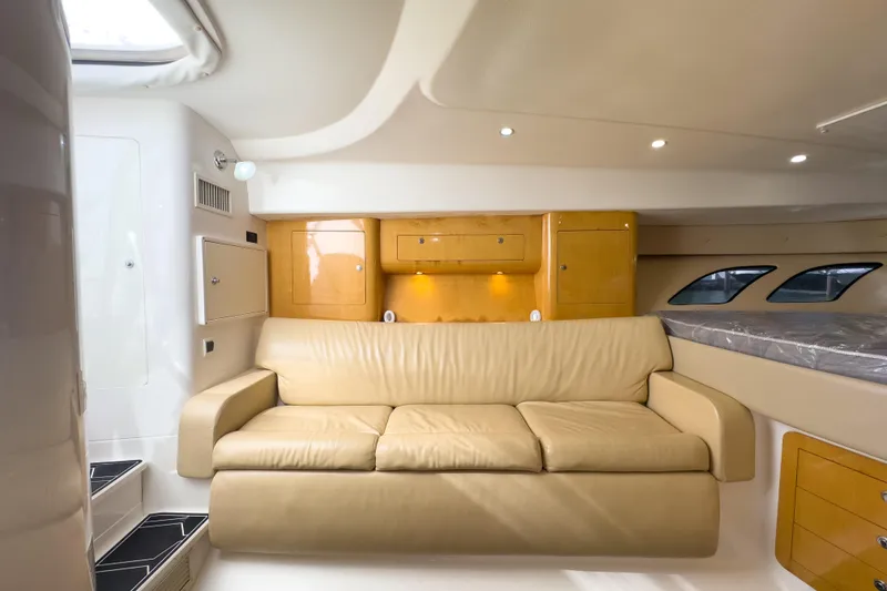 Slide: The Image of Interior of 2008 Intrepid 390 Sport Yacht with beige leather sofa and wooden cabinets. - 18