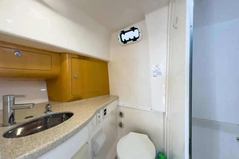 Slide: The Image of 2008 Intrepid 390 Sport Yacht bathroom with sink, toilet, and storage cabinets. - 23
