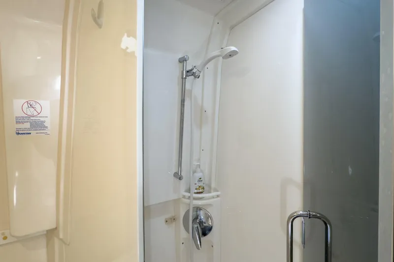 Slide: The Image of Shower area in 2008 Intrepid 390 Sport Yacht, featuring modern fixtures and a sleek design. - 25