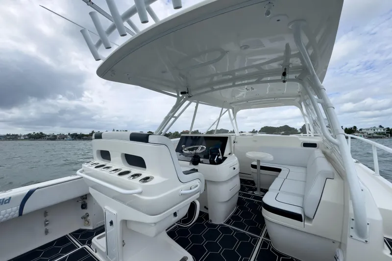 Slide: The Image of 2008 Intrepid 390 Sport Yacht interior with helm, seating, and ocean view. - 27