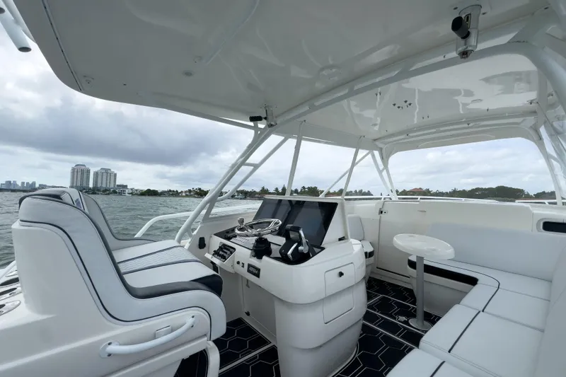 Slide: The Image of 2008 Intrepid 390 Sport Yacht interior with helm, seating, and ocean view. - 28