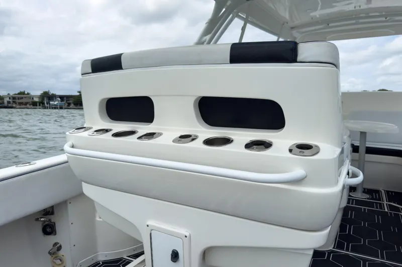 Slide: The Image of 2008 Intrepid 390 Sport Yacht interior with seating and cup holders, overlooking water. - 31