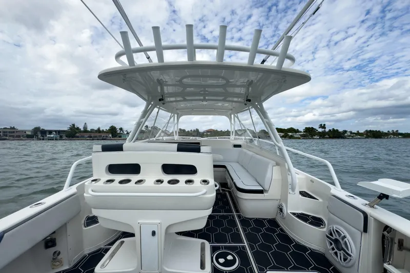 Slide: The Image of 2008 Intrepid 390 Sport Yacht on water, featuring spacious seating and sleek design. - 32