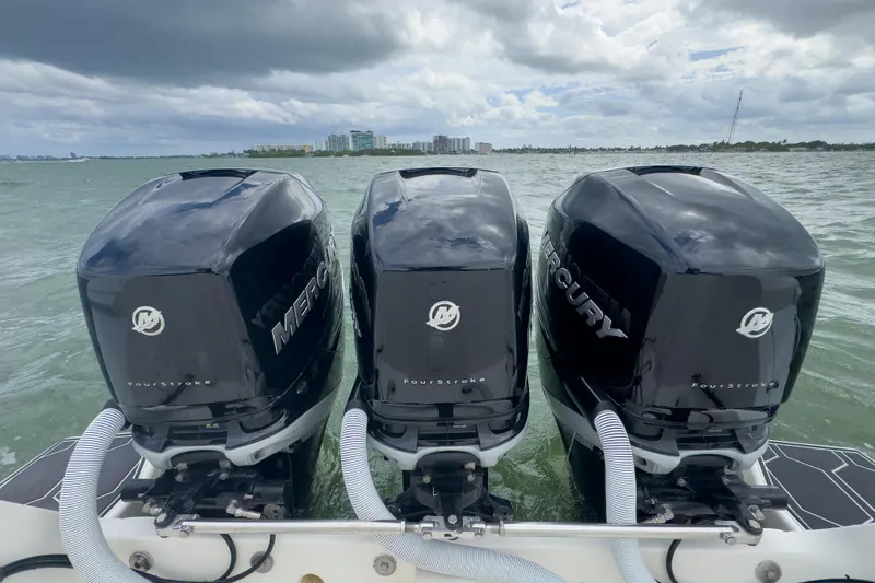 Slide: The Image of Triple Mercury outboard engines on a 2008 Intrepid 390 Sport Yacht in open water. - 33