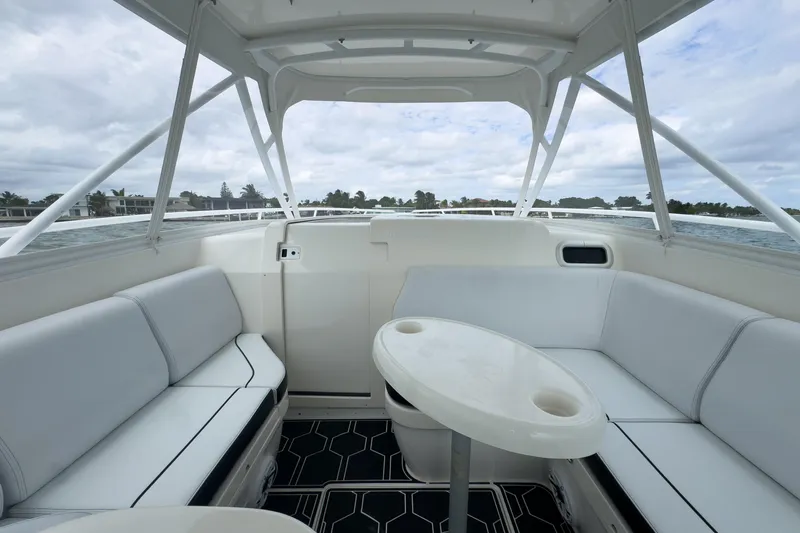 Slide: The Image of Interior view of 2008 Intrepid 390 Sport Yacht with white seating and table. - 39