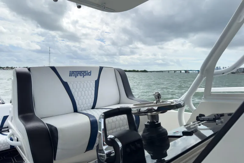 Slide: The Image of 2008 Intrepid 390 Sport Yacht helm with scenic water view and cloudy sky. - 41