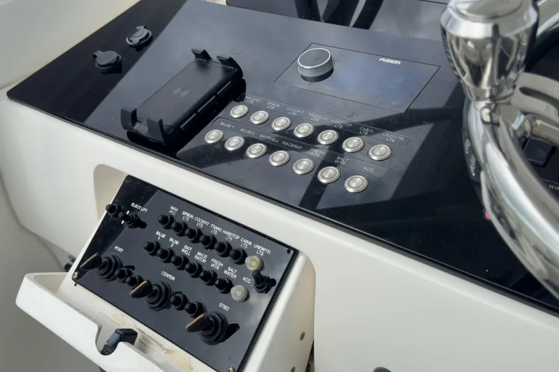 Slide: The Image of Control panel of a 2008 Intrepid 390 Sport Yacht with steering wheel and buttons. - 42