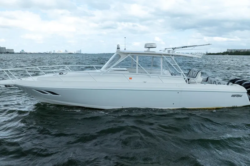 Slide: The Image of 2008 Intrepid 390 Sport Yacht cruising on open water under cloudy skies. - 6