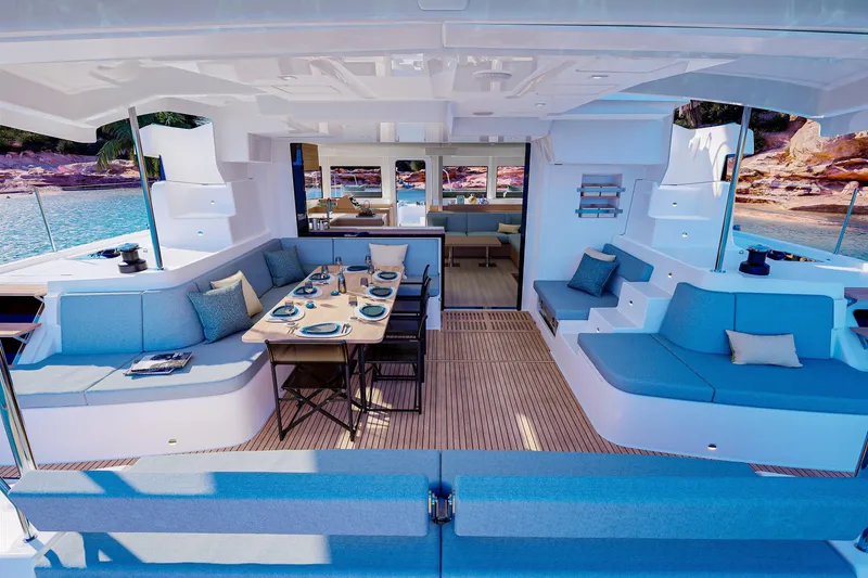Slide: The Image of Luxurious Lagoon 47 yacht interior, 2026 model, featuring elegant seating and dining area by the sea. - 3
