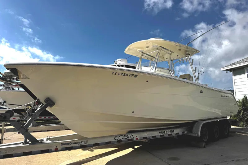 The Image of 2016 Cobia 296 Center Console boat on trailer. - 0