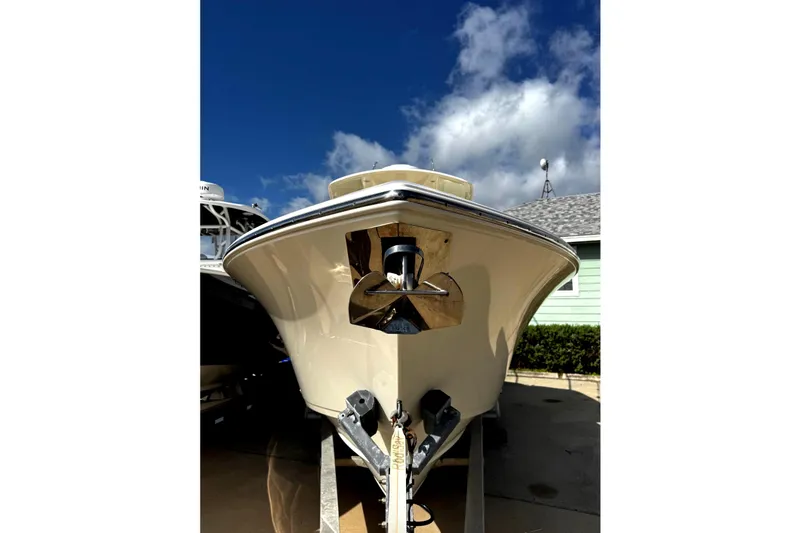 Slide: The Image of 2016 Cobia 296 Center Console boat on trailer under blue sky. - 1