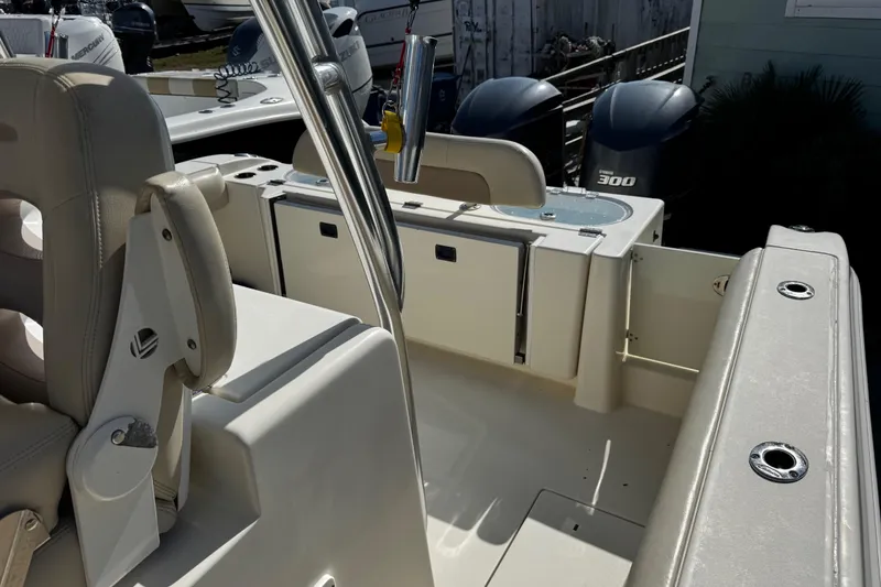 Slide: The Image of 2016 Cobia 296 Center Console boat interior with seating and dual Yamaha 300 engines. - 11