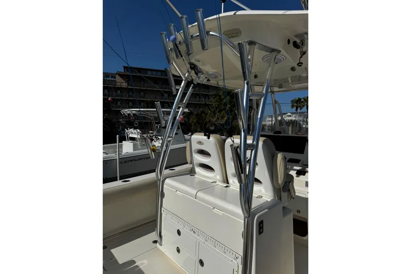 Slide: The Image of 2016 Cobia 296 Center Console boat with seating and rod holders. - 12