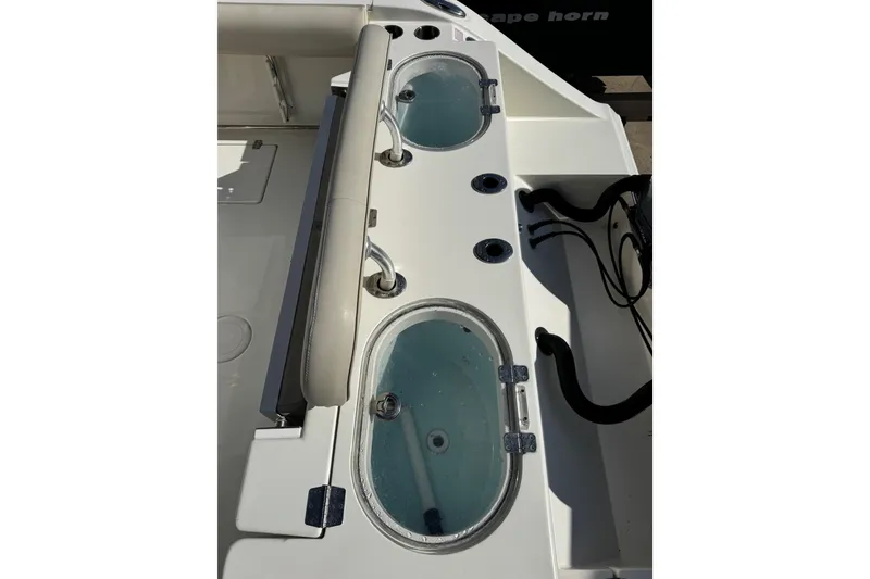 Slide: The Image of 2016 Cobia 296 Center Console boat with dual livewells and rod holders. - 13