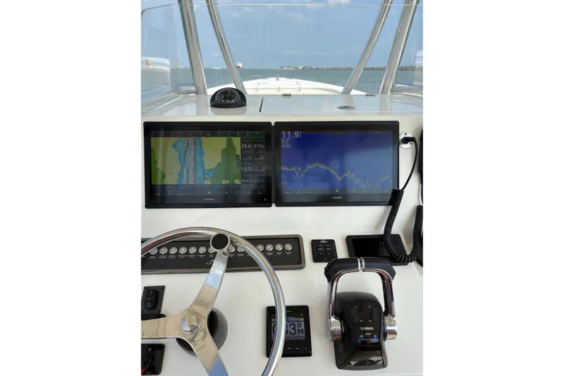 Slide: The Image of 2016 Cobia 296 Center Console helm with dual Garmin displays and Yamaha controls. - 14