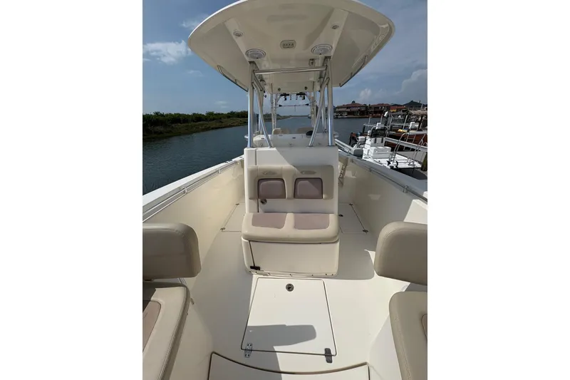 Slide: The Image of 2016 Cobia 296 Center Console boat interior with seating and console view. - 19