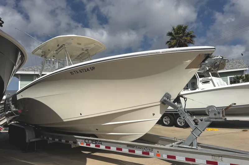 Slide: The Image of 2016 Cobia 296 Center Console on trailer, side view. - 2