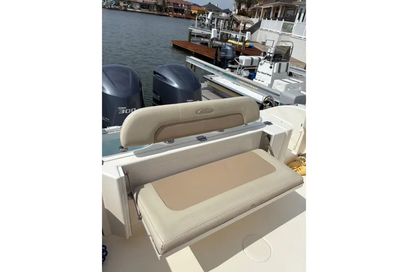 Slide: The Image of 2016 Cobia 296 Center Console boat with Yamaha engines, docked by waterfront homes. - 20